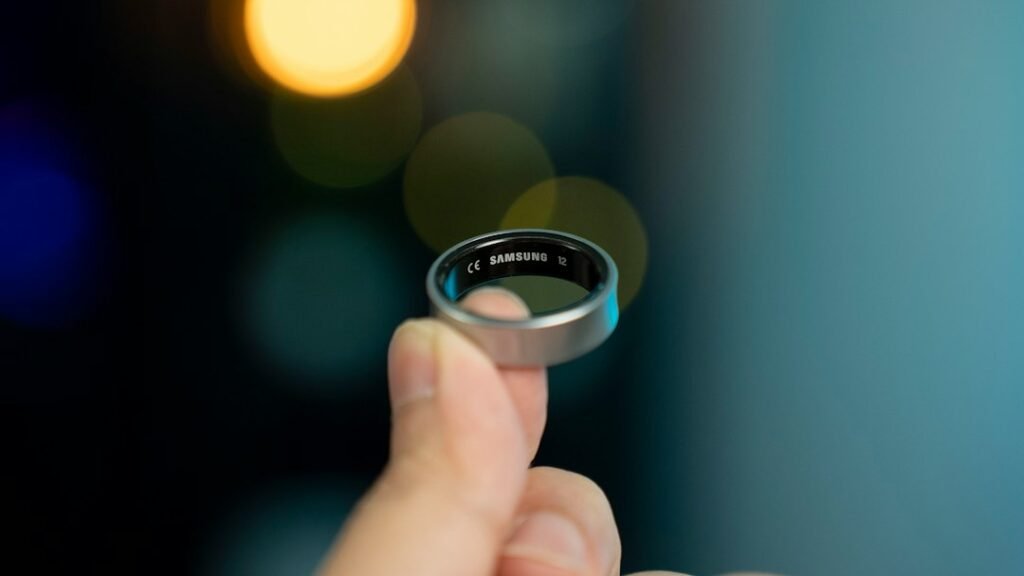 Hand holding an Oura smart ring