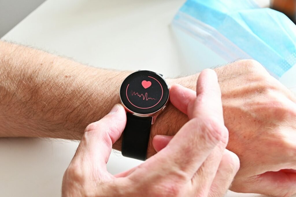 Person checking a health monitor on a wrist-worn device