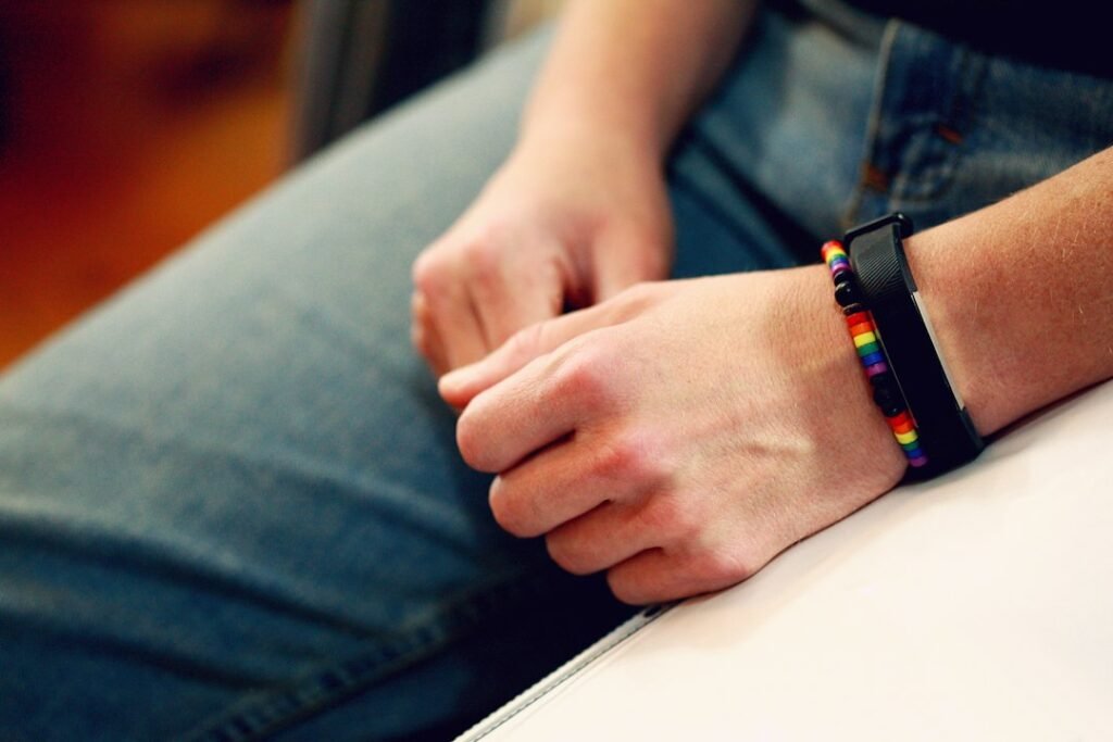 Person wearing a fitness smartwatch, Fitbit vs Garmin comparison